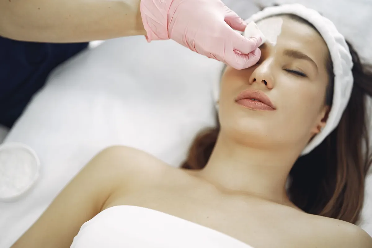Provider performing precise microneedling skin treatment in a modern medical aesthetic clinic setting