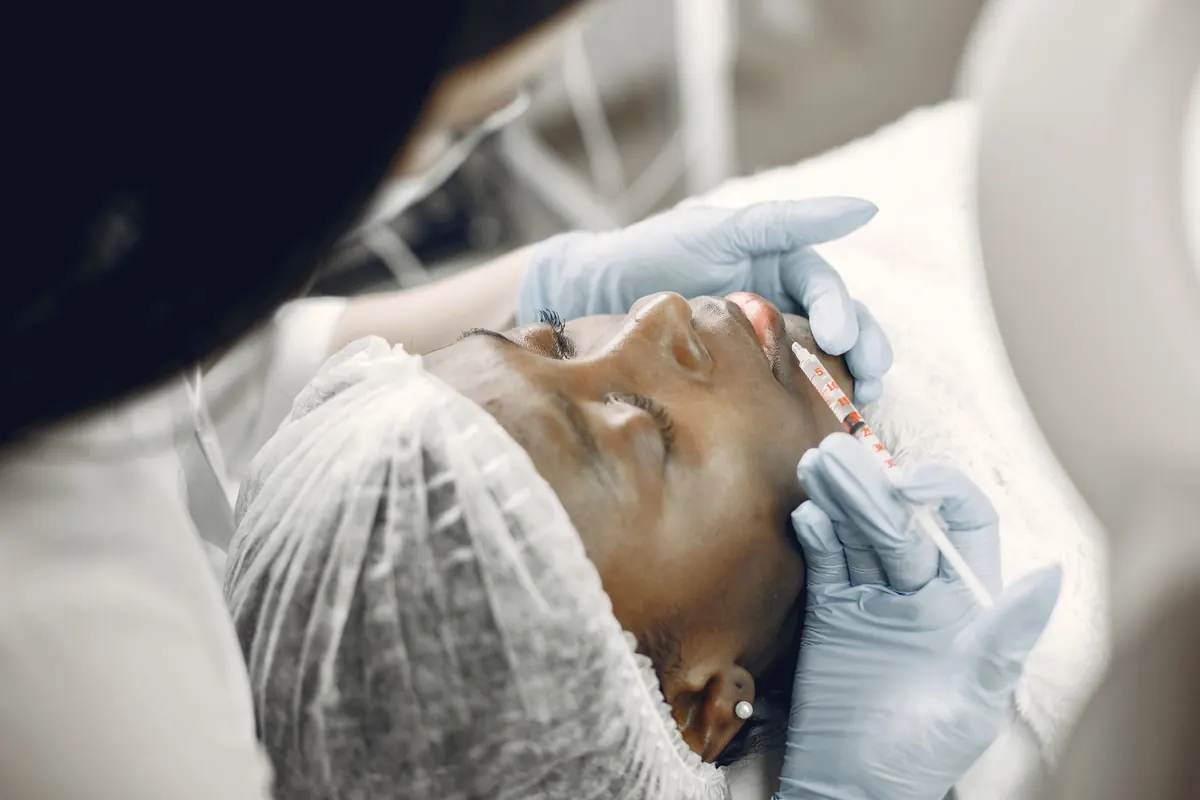Client discussing facial contouring and jawline treatment options with medical provider