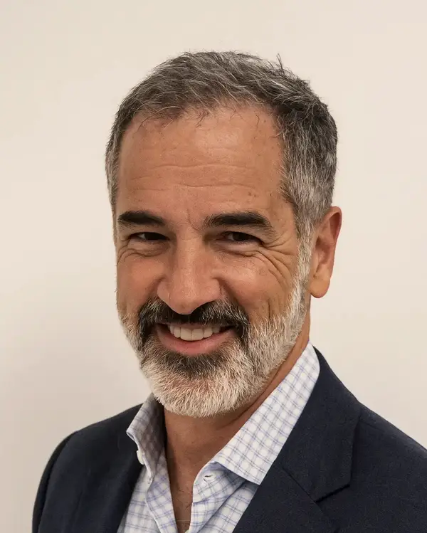 Dr. Steven Freedman, MD, smiling in a navy jacket.